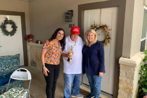 Alexis Pointe of Wimberley | Senior resident, Jack Roach wearing red hat and holding up trophy
