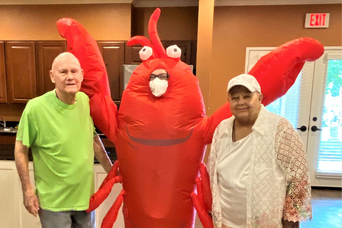 Arabella of Athens | Senior couple posing next to a man dressed as a lobster