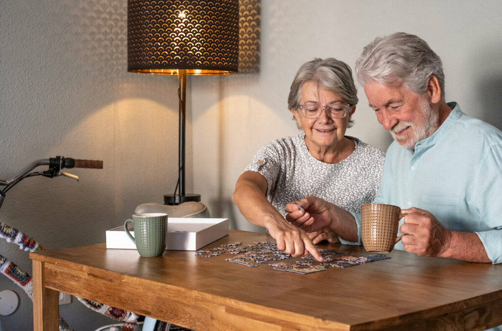 Arabella of Red Oak | Two happy seniors doing a puzzle together