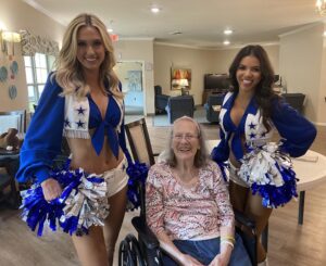 Dancing River | Dallas Cowboys cheerleaders with smiling senior