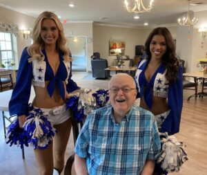 Dancing River | Dallas Cowboys cheerleaders with smiling senior