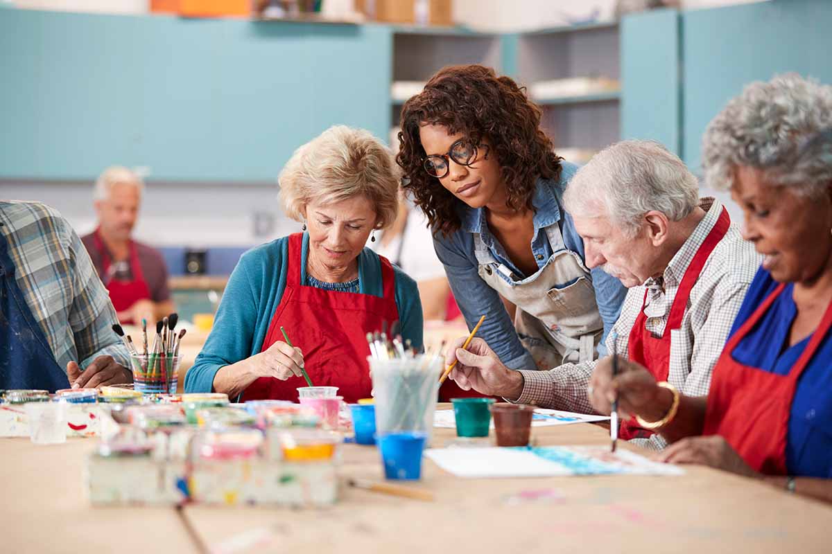 Legacy Oaks of Azle | Group Of Retired Seniors Attending Art Class In Community Centre With Teacher