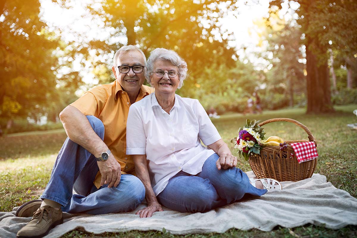 Legacy Oaks of Midlothian | Happy and handsome senior couple enjoying a picnic in the park