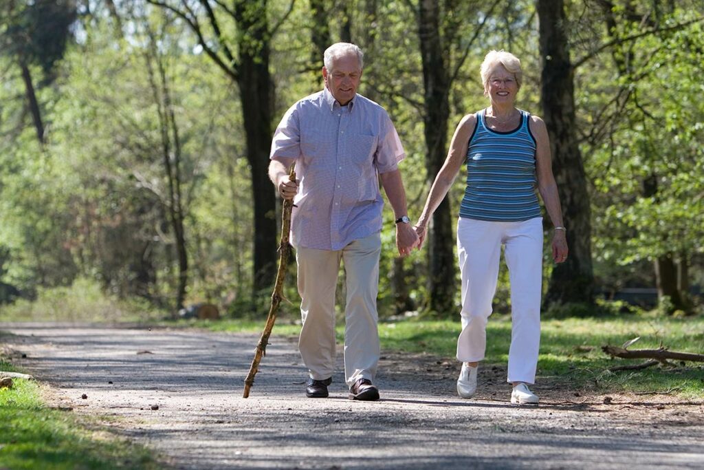 StoneCreek of Littleton | Senior couple walking in nature