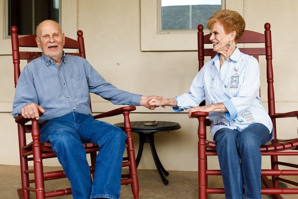 Civitas Senior Living | Couple holding hands on a porch