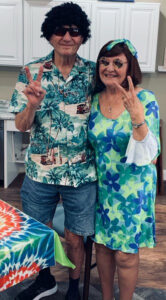 The Brooks of Cibolo | Seniors wearing hippie wigs, smiling and flashing peace signs