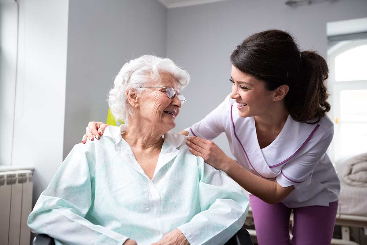 The Ridglea | Satisfied and happy senior woman patient with nurse at nursing home