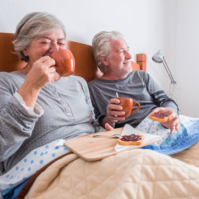 Arabella of Athens | Senior couple having breakfast in bed