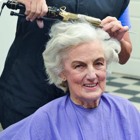 Civitas Senior Living | Senior woman smiling and getting her hair curled