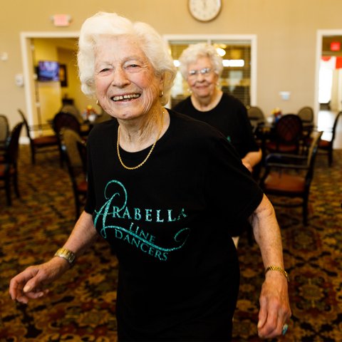 Arabella of Longview | Senior woman smiling in a Arabella community shirt