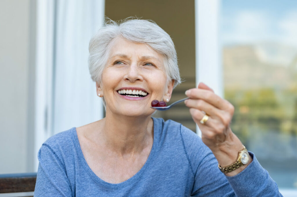 Arabella of Longview | Senior woman eating grapes