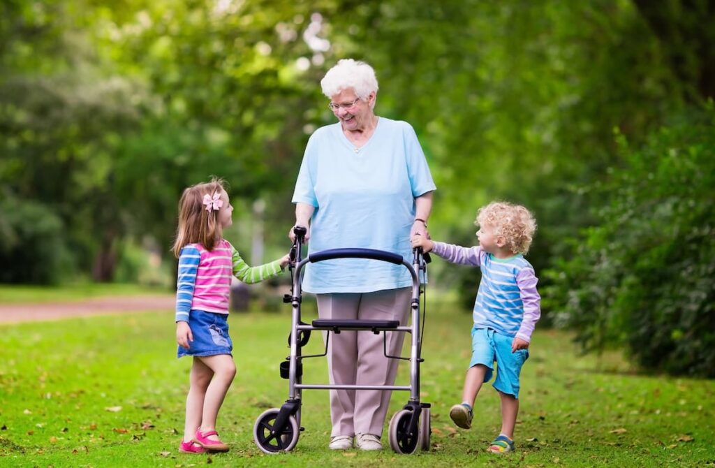 Arabella of Red Oak - Dallas Alzheimer's Care | Senior woman with visiting family members walking outside together