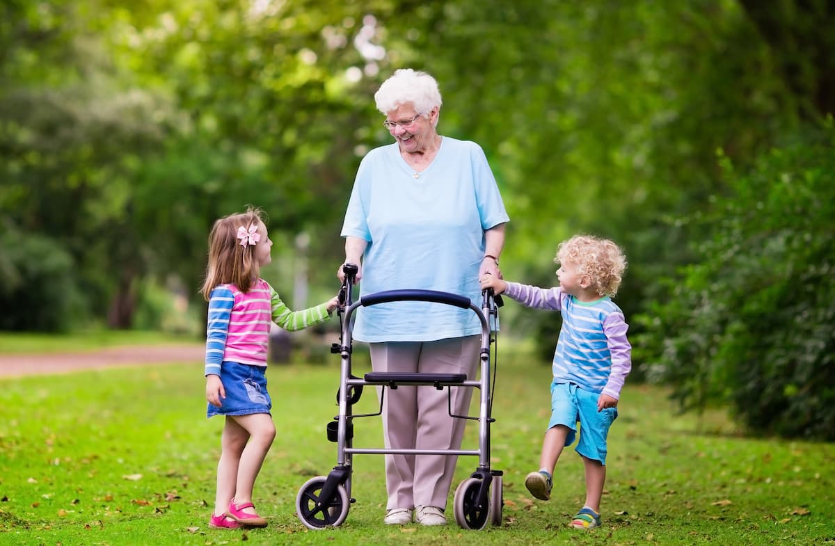 Arabella of Red Oak - Dallas Alzheimer's Care | Senior woman with visiting family members walking outside together