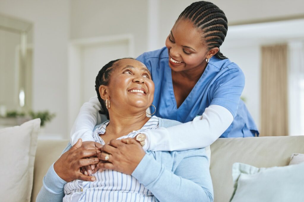 Arabella of Red Oak | Senior woman smiling and embracing with caregiver