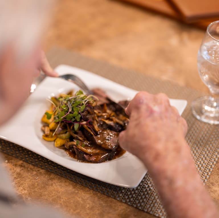 Ariel Pointe of Sachse | Resident enjoying chef-prepared meal