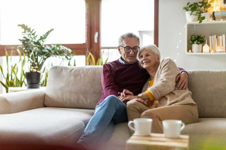 Ariel Pointe of Sachse | Senior couple sitting on couch in their apartment