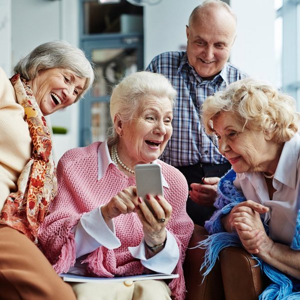 Autumn Wind | Group of seniors looking at phone