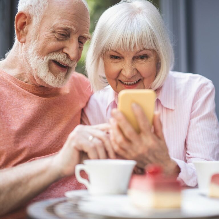 Autumn Wind | Senior couple looking at phone