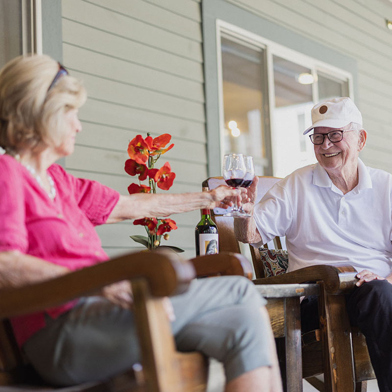 Autumn Wind | Senior man and woman toasting wine glasses