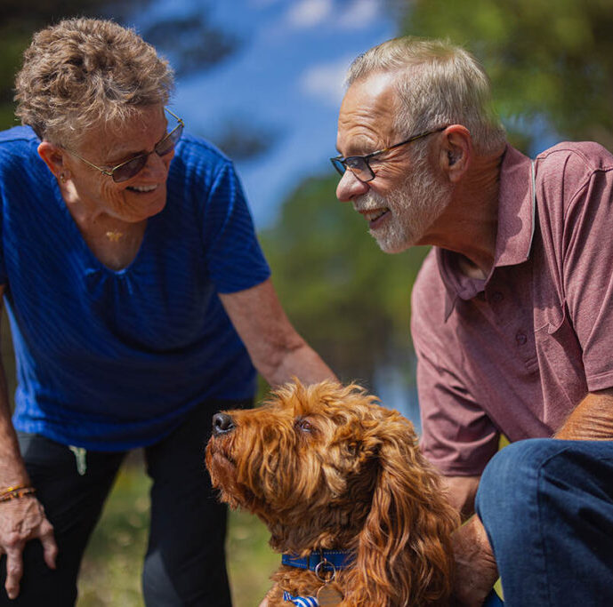 Autumn Wind | Senior man and woman with golden doodle