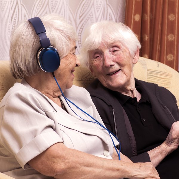 Cambridge Court | Senior women listening on headphones