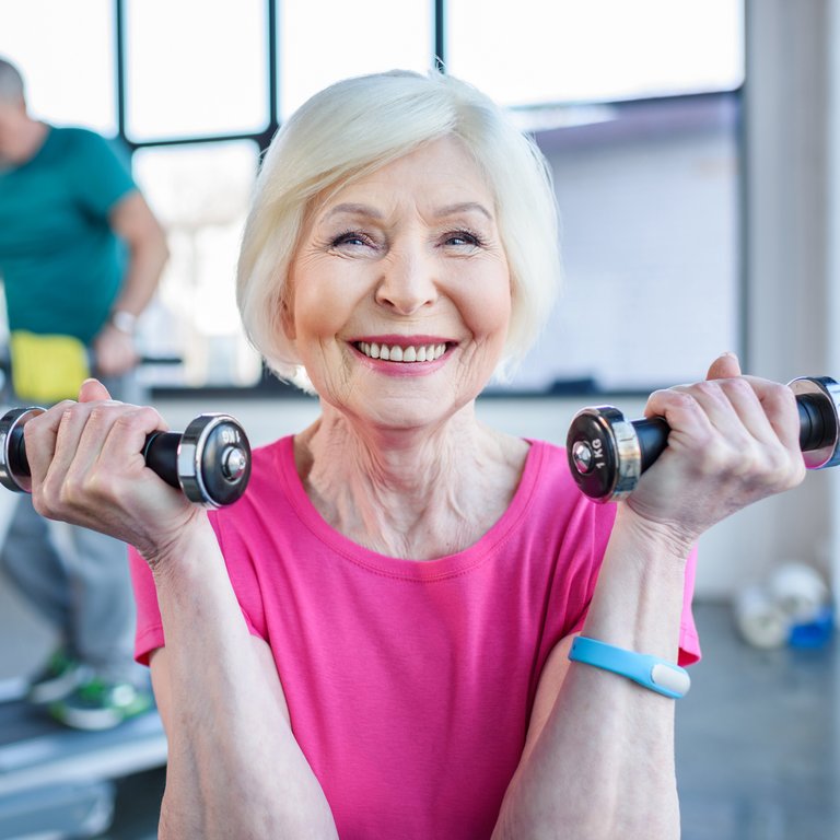 Cambridge Court | Senior woman lifting handheld weights