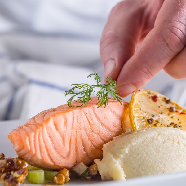 Clear Fork | Chef garnishing salmon