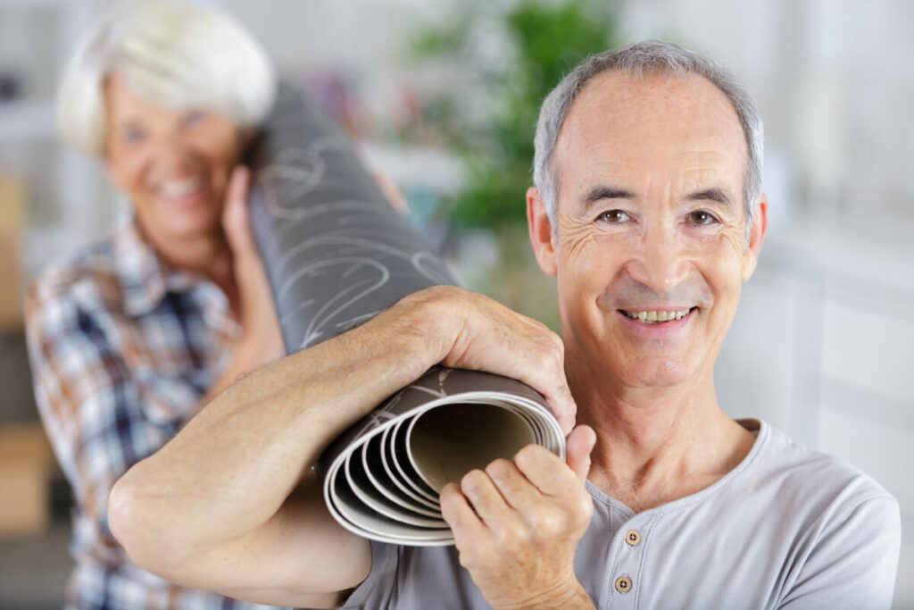 Civitas Senior Living | Senior couple caring a carpet