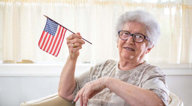 Double Creek | Senior woman holding a minature American flag