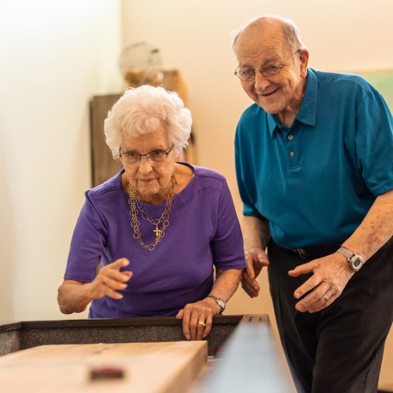 Double Creek | Senior couple playing games together in activity room