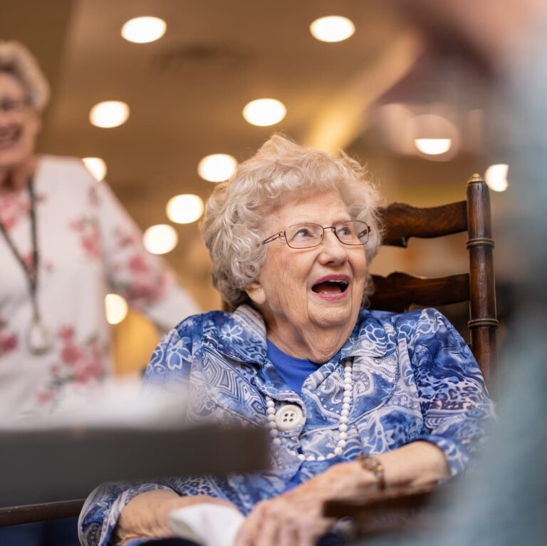 Double Creek | Senior woman in dining room with friends