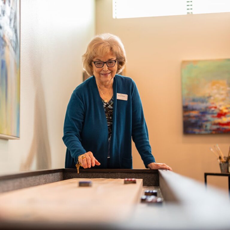 Double Creek | Senior woman playing game in activity room