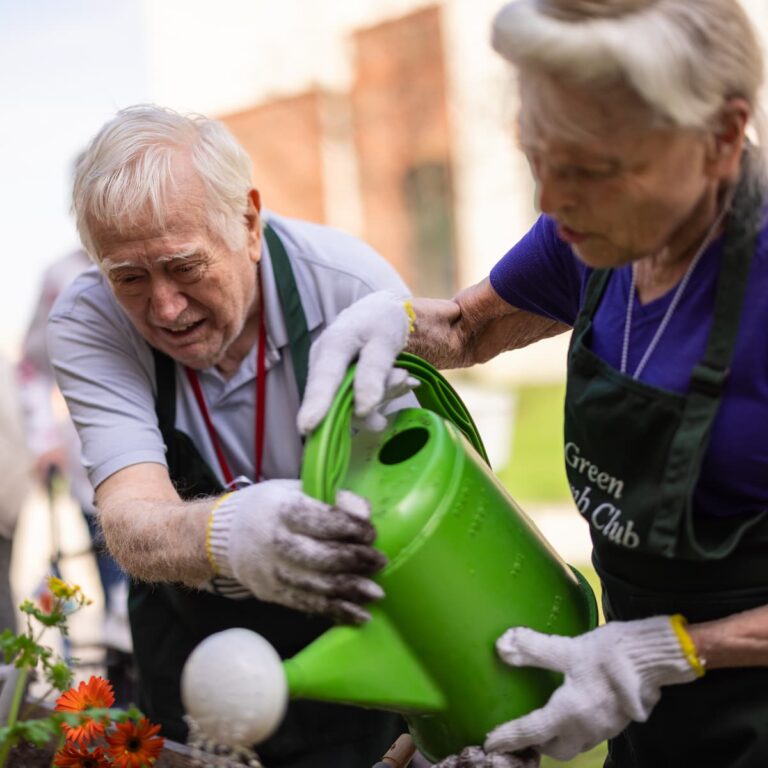 Double Creek | Seniors watering flowers together Green Thumb Club