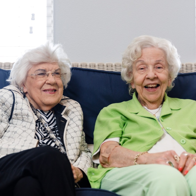 Double Creek | Residents sitting on a couch smiling