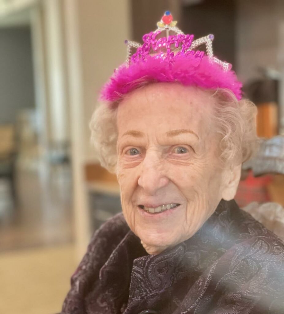 Double Creek | Senior resident Meg wearing a pink birthday hat
