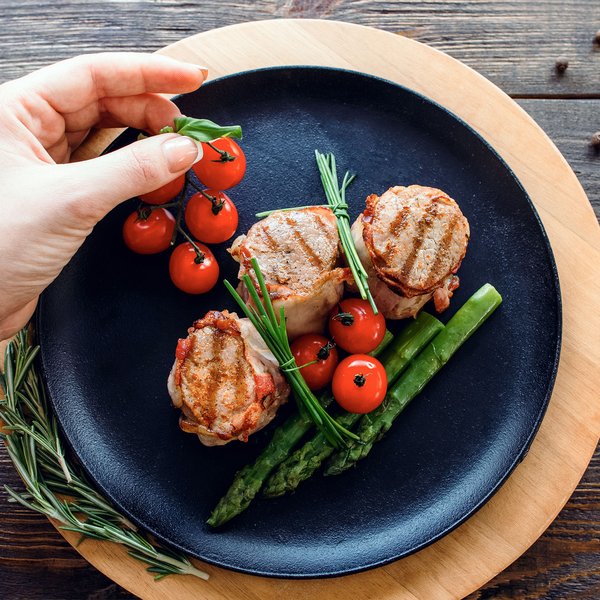 Elk Creek | Chef garnishing dish with tomatoes