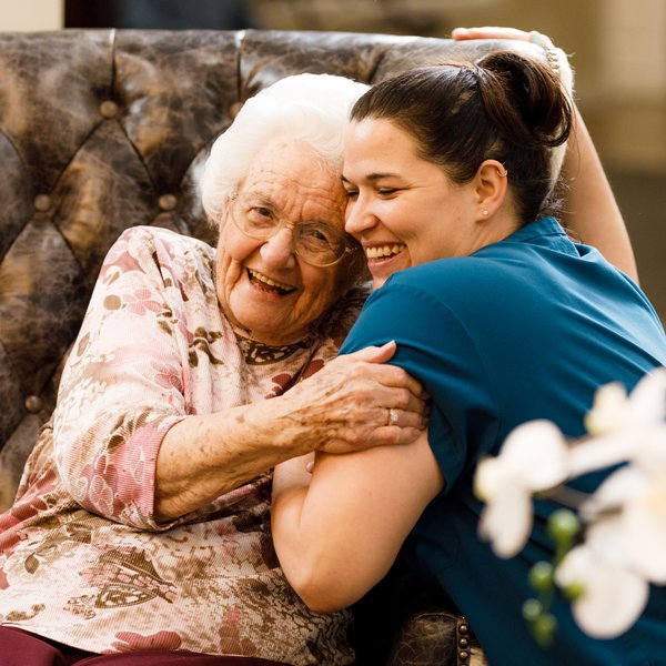 Elk Creek | Associate hugging resident