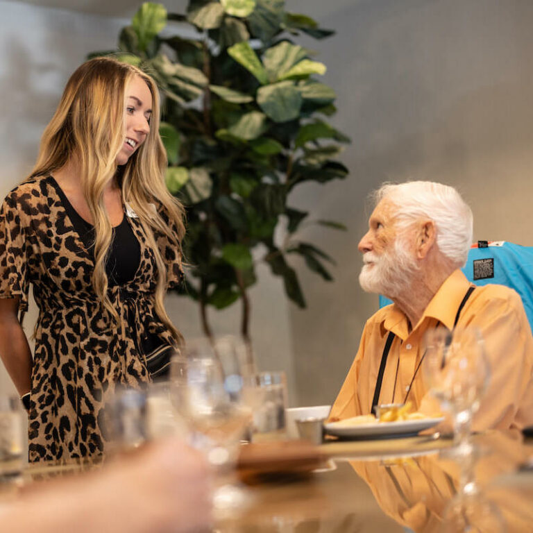 Elk Creek | Senior talking to his caregiver at dinner