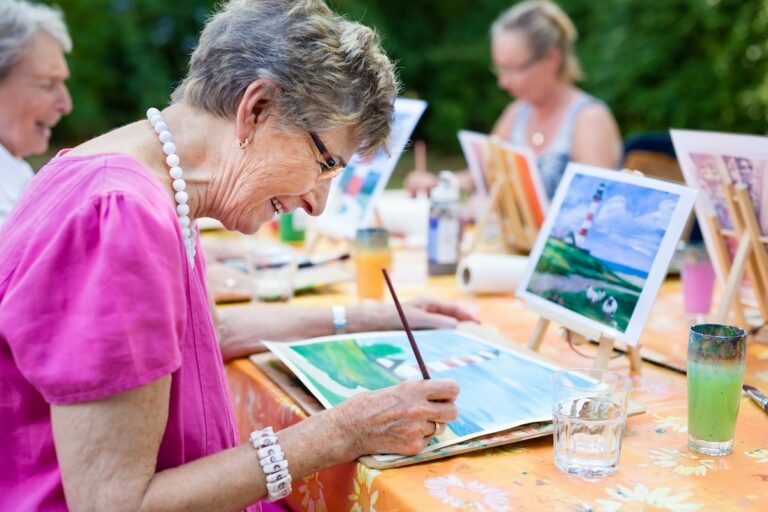 Elk Creek | Senior woman painting outsie