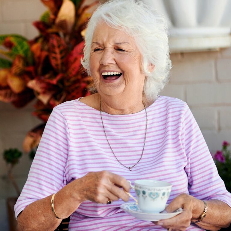 Harvest of Aledo | Senior woman smiling with teacup in her hands