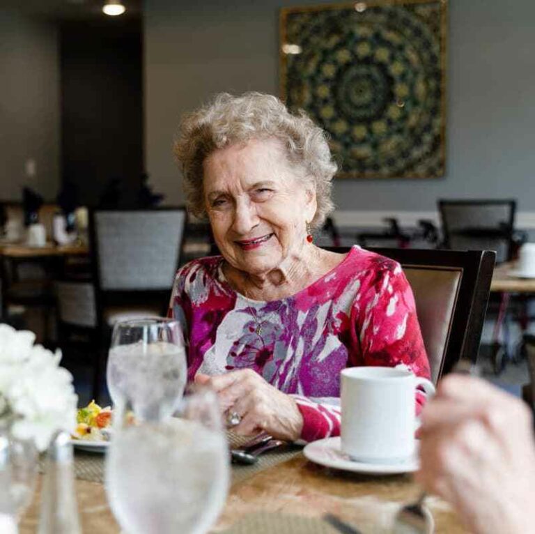 Harvest of Aledo | Senior living community resident sitting in the dining room