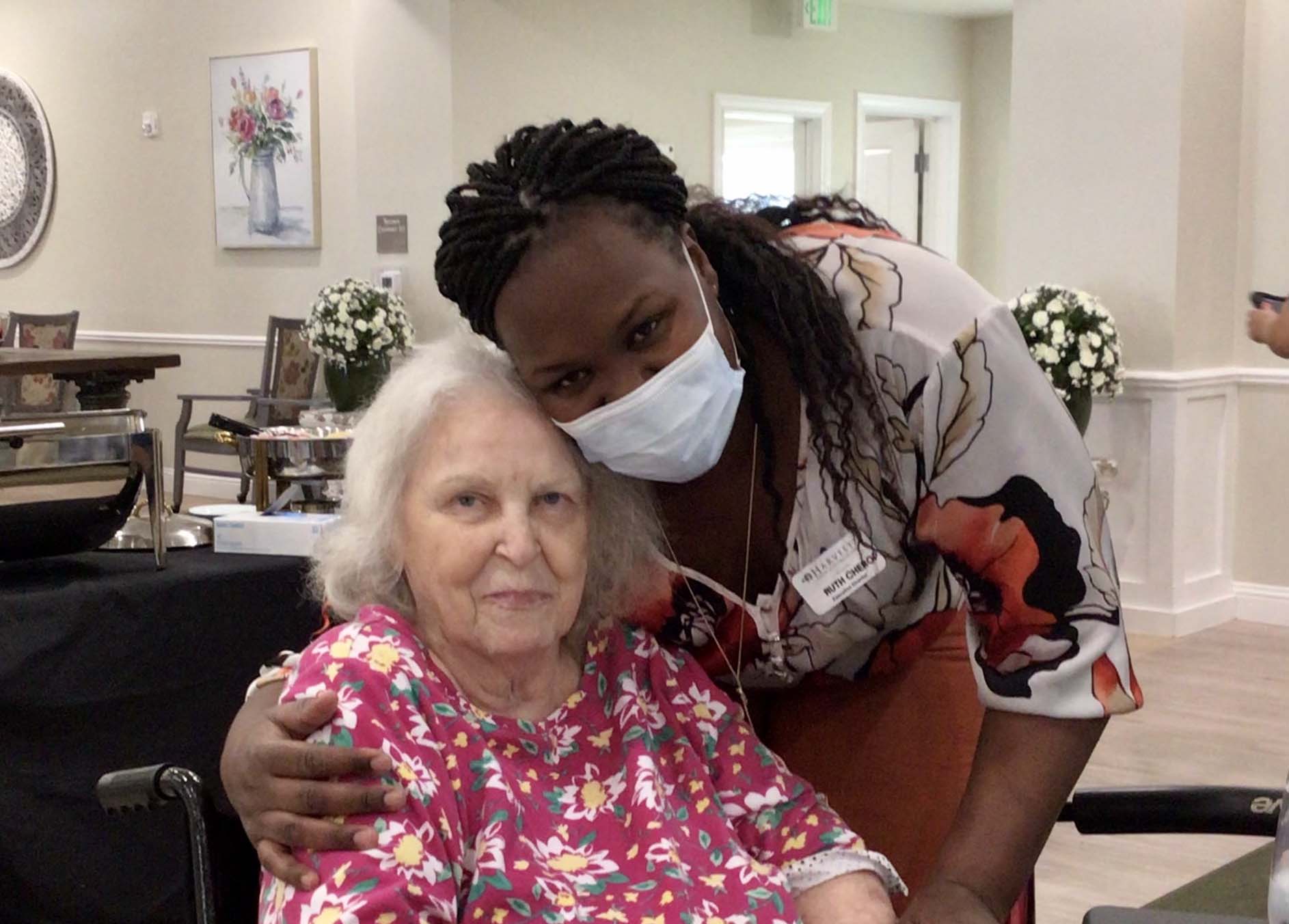 The Harvest of Roanoke | senior resident and executive director at table smiling