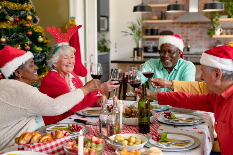 Civitas Senior Living | Seniors having a Christmas dinner wearing Christmas hats