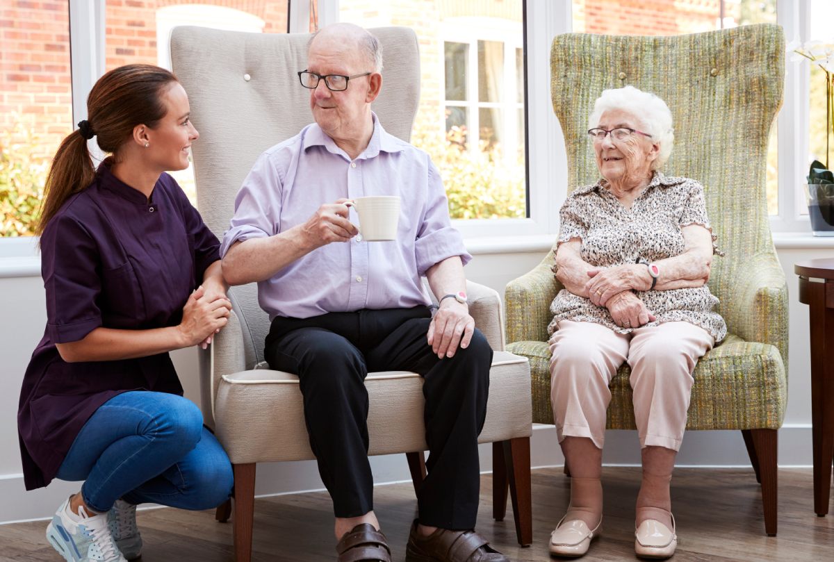 Ledgestone | Senior man and woman talking with caregiver