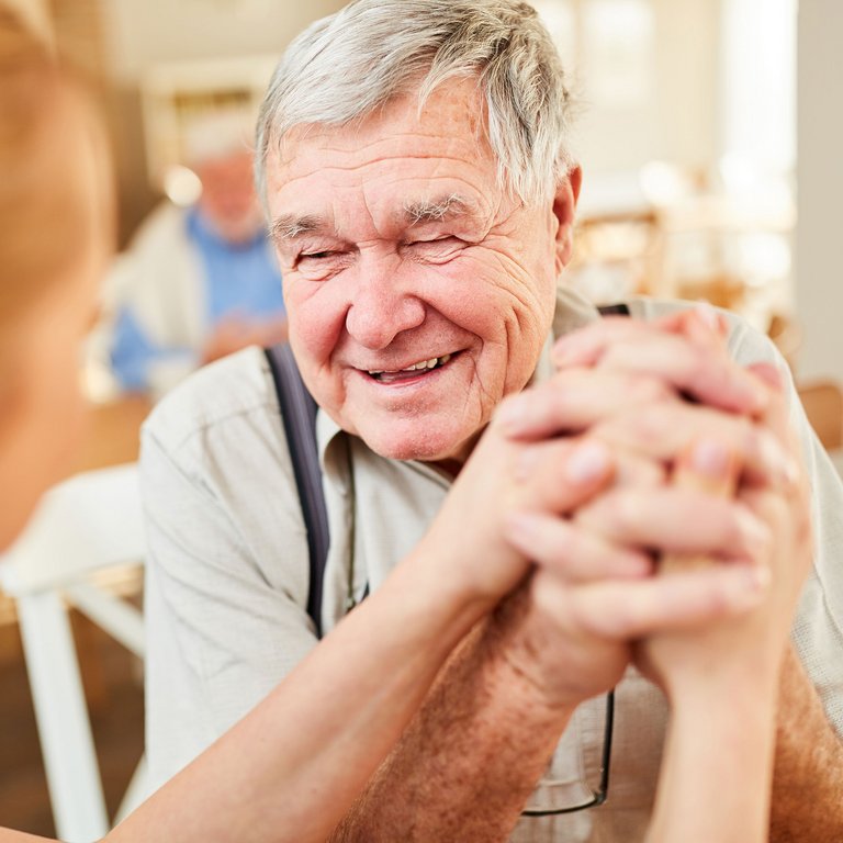 Ledgestone Senior Living | Senior man holding hands
