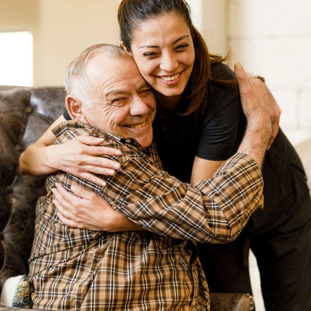 Ledgestone Senior Living | Senior man and associate hugging