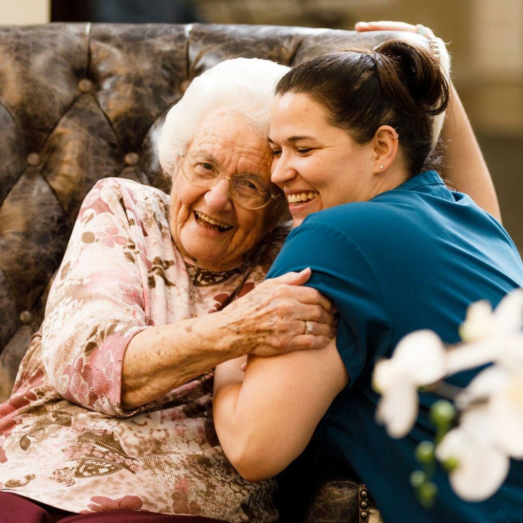 Ledgestone Senior Living | Senior woman hugging associate
