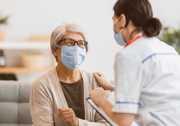 Ledgestone Senior Living | Nurse talking to senior women with face masks on