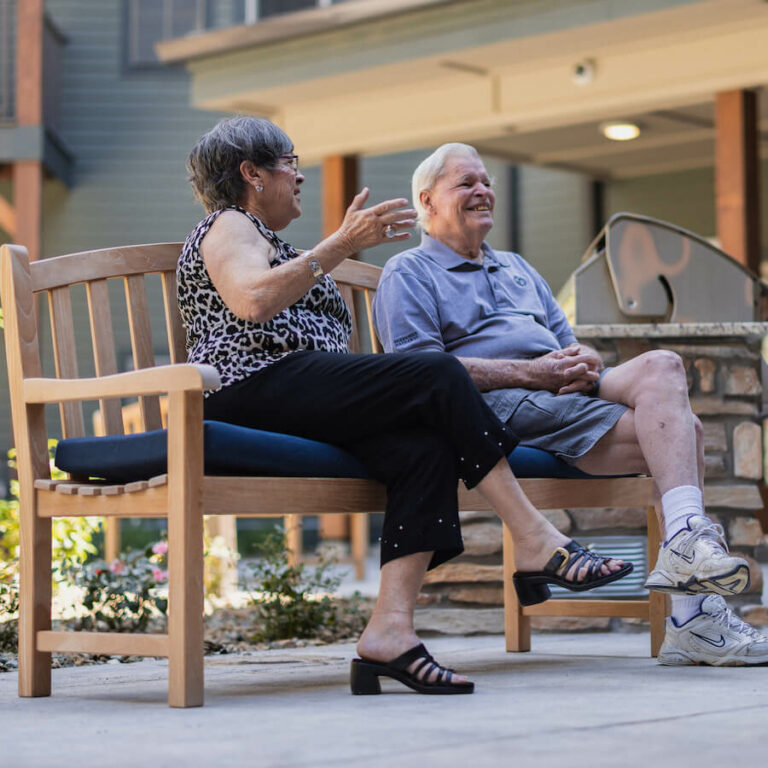 Legacy Oaks of Azle | Seniors chatting on a bench