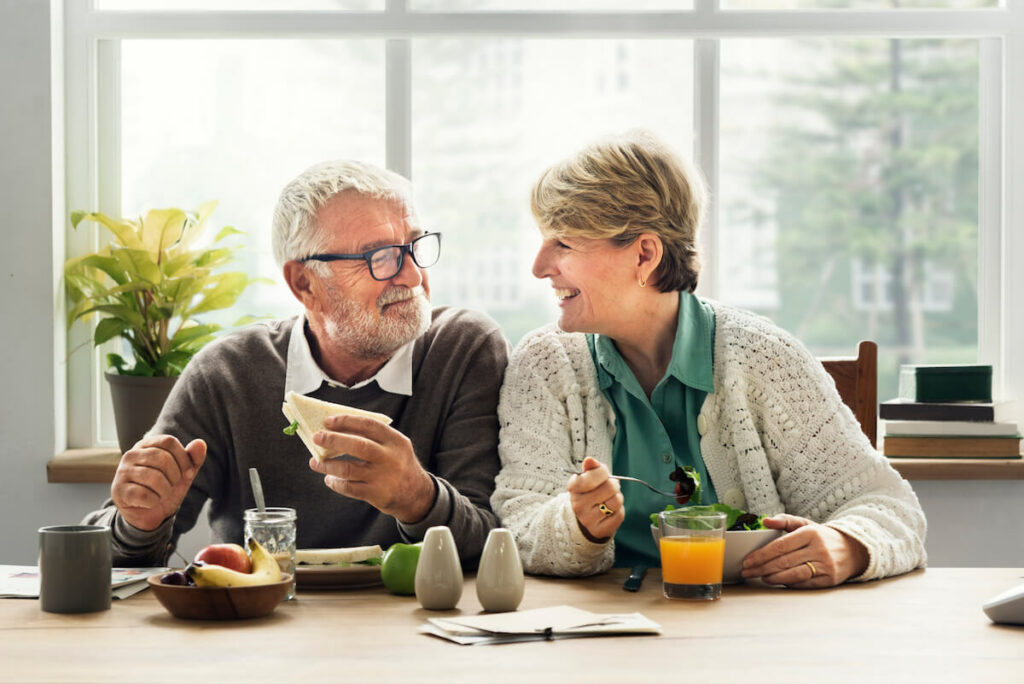 Legacy Oaks of Azle | Happy senior couple eating a healthy mean together